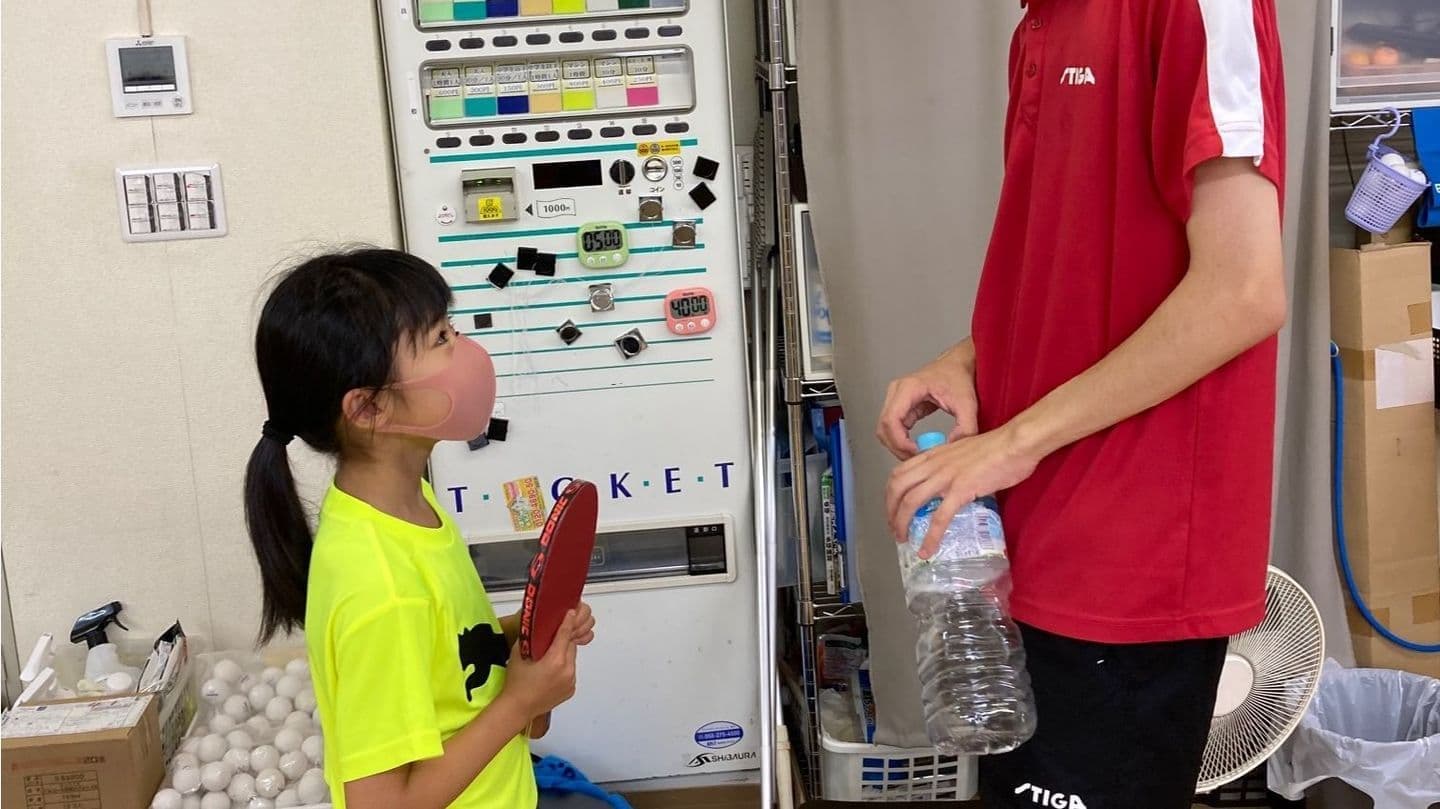 品川区西五反田のOverLight卓球道場のジュニア選手が個人レッスンでコーチからアドバイスを受けている様子